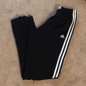 Black adidas pants with white stripes on the sides